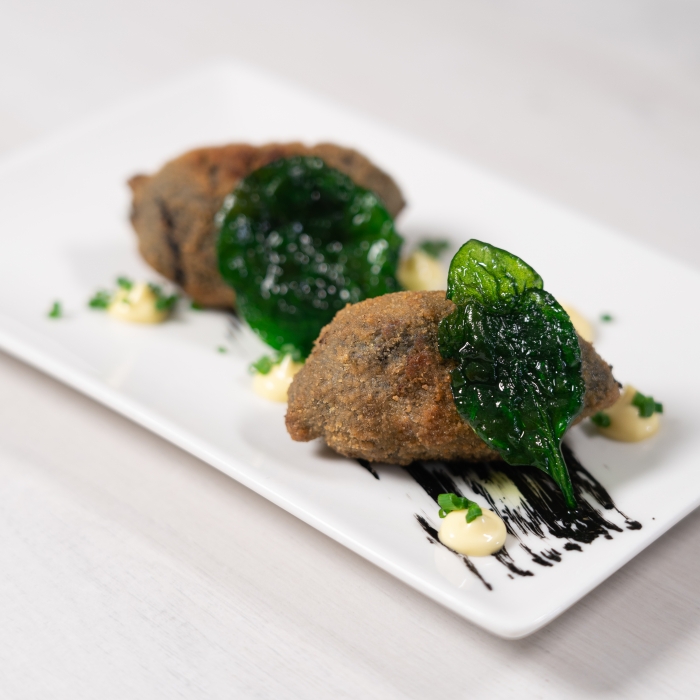 Croquettes of baby squid with Alioli and fried spinach 